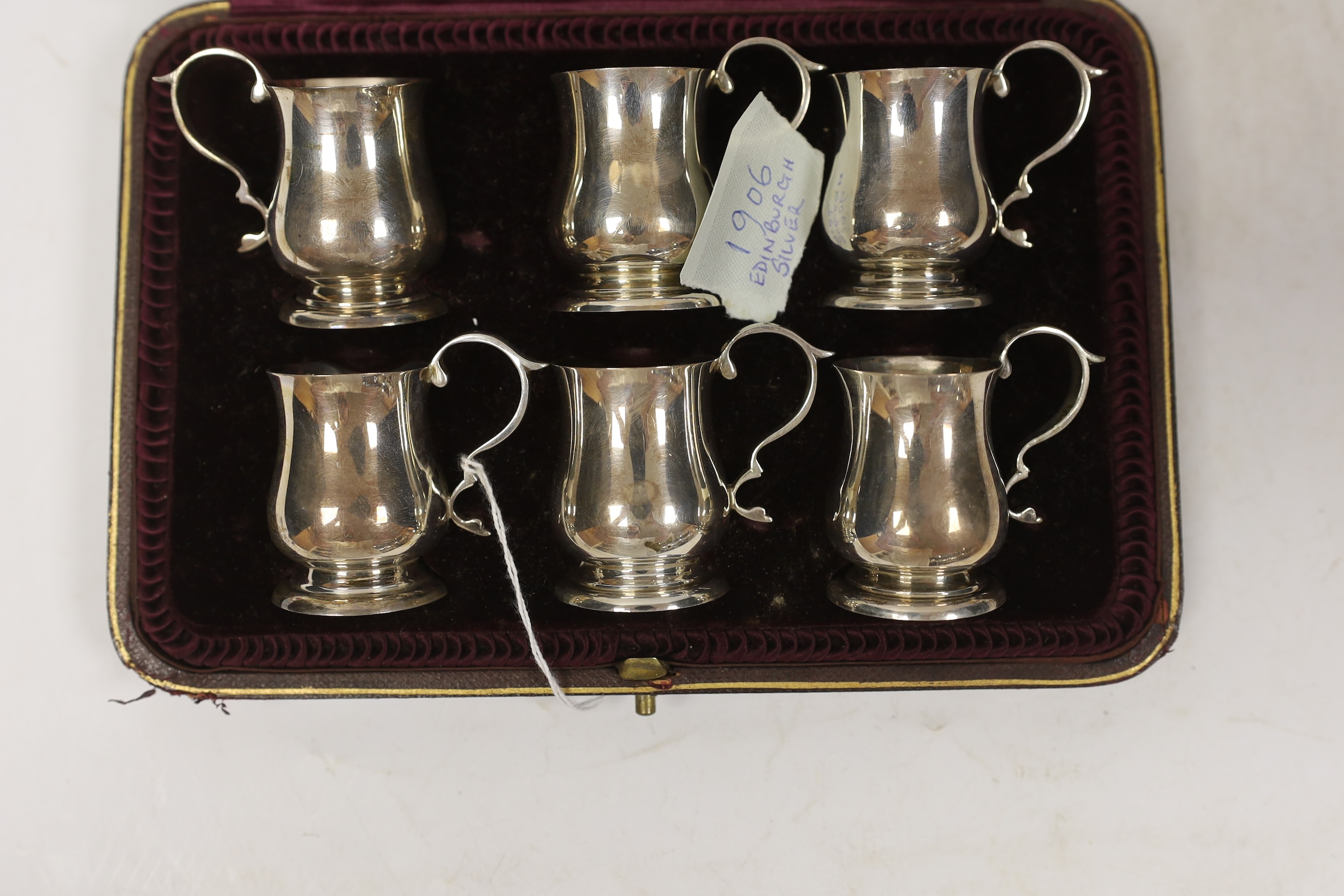 An Edwardian cased set of six miniature baluster mug tots, Hamilton & Inches, Edinburgh, 1906, 49mm.